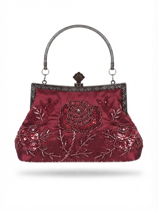 A burgundy satin evening clutch bag with intricate floral sequin and bead embroidery, featuring a silver-tone metal handle and frame closure.